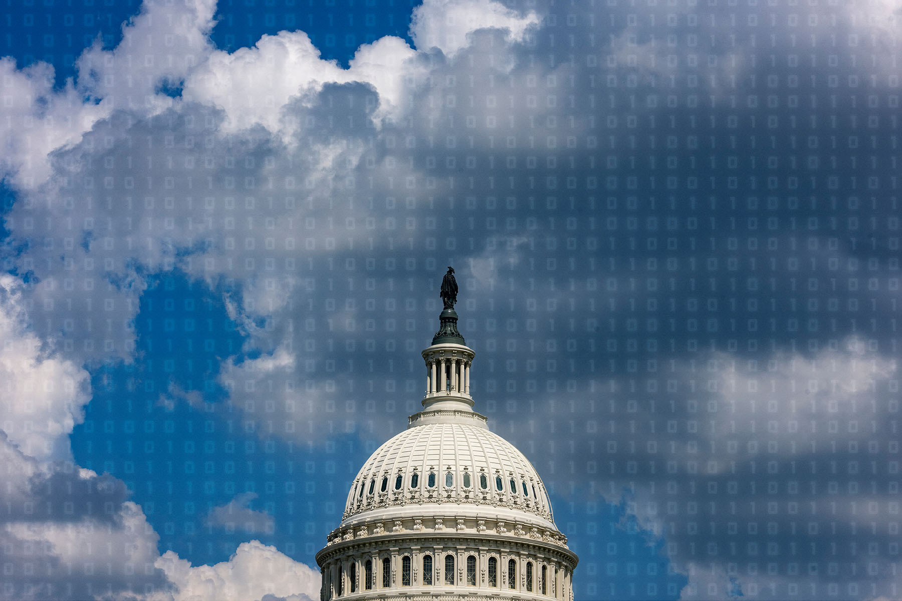 Capitol building against a blue sky with binary code on top of it.