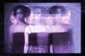 A digitally manipulated portrait of a young woman with short curly hair in a dark tank top, shown in three ghostly exposures side by side.