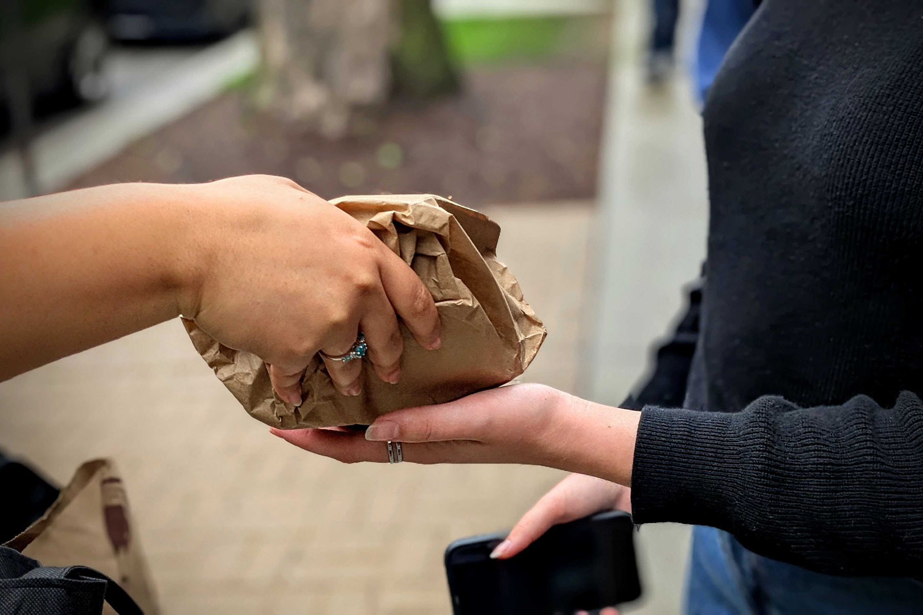 DePaul University student Maya Roman hands off a bag of condoms and other birth control to a volunteer.