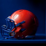An american football helmet sits in an empty locker.