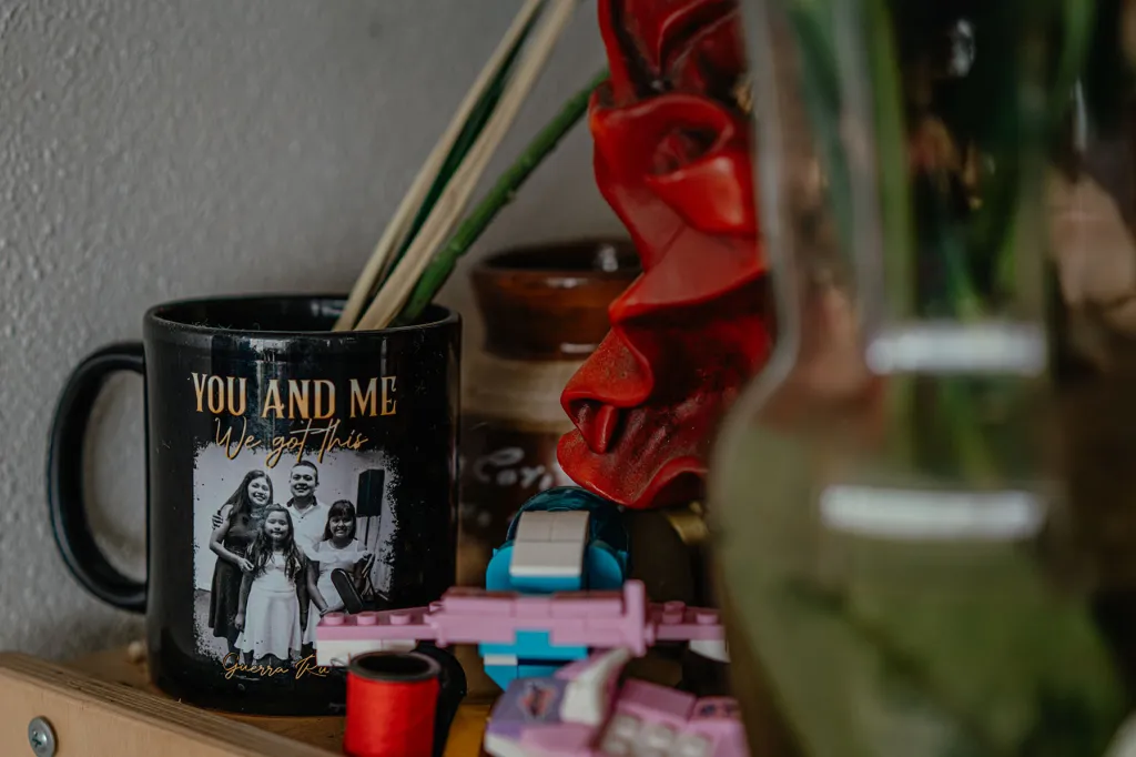 A mug sits on a shelf with a photo of Yessenia Ruano, her husband and daughters at their civil ceremony.