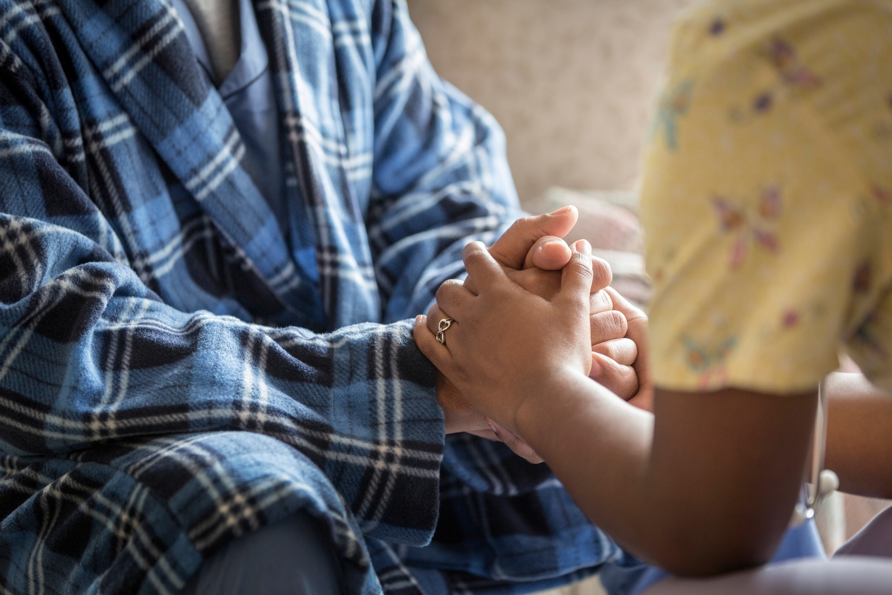 An image depicts two people holding hands.