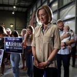 Karrin Taylor Robson pauses for prayer at a campaign rally.