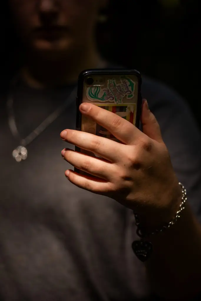 A close up of a hand holding a phone.