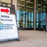 Directions to a measles vaccination site are seen outside of the Lubbock Public Health facility.