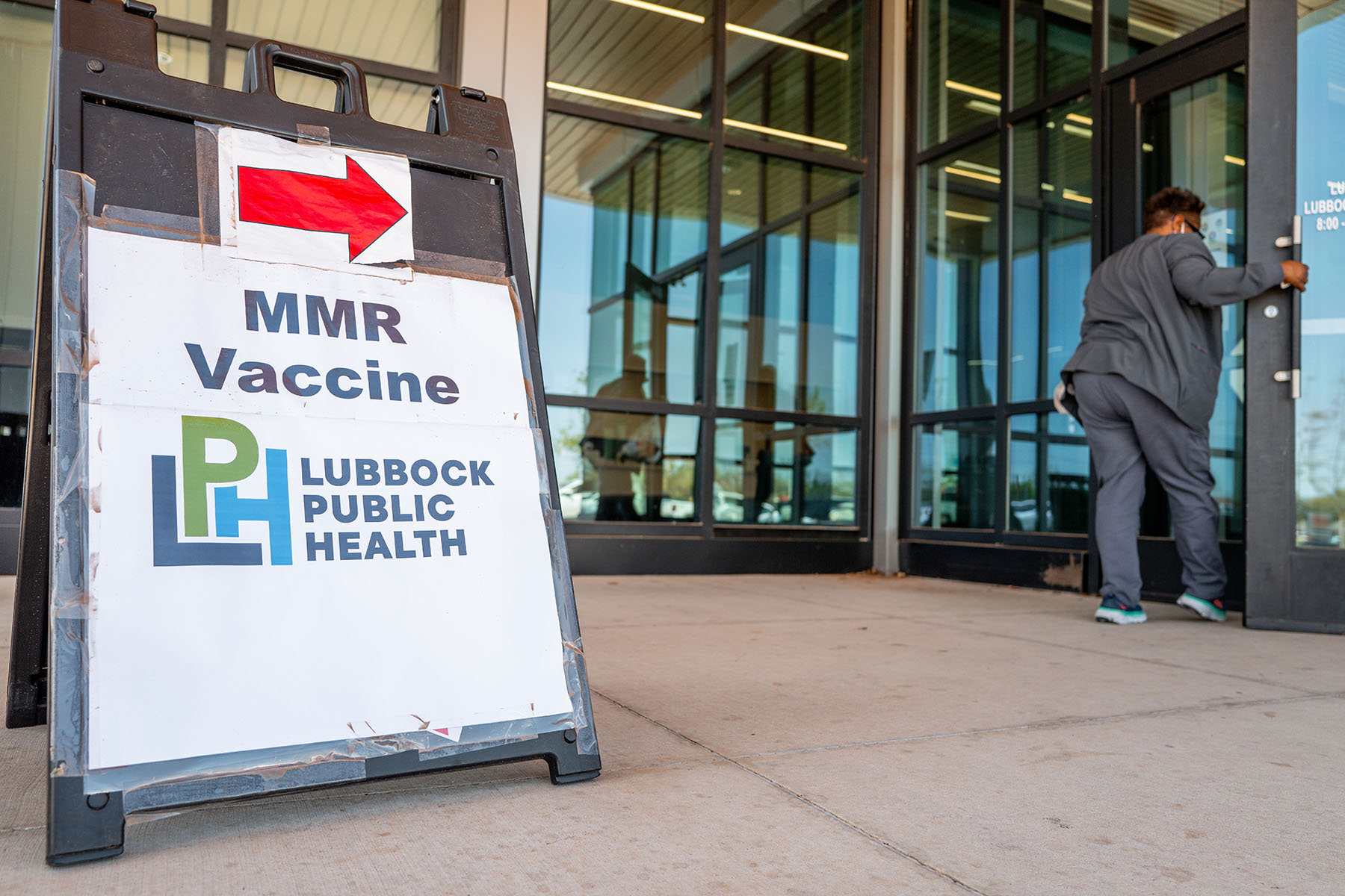 Directions to a measles vaccination site are seen outside of the Lubbock Public Health facility.