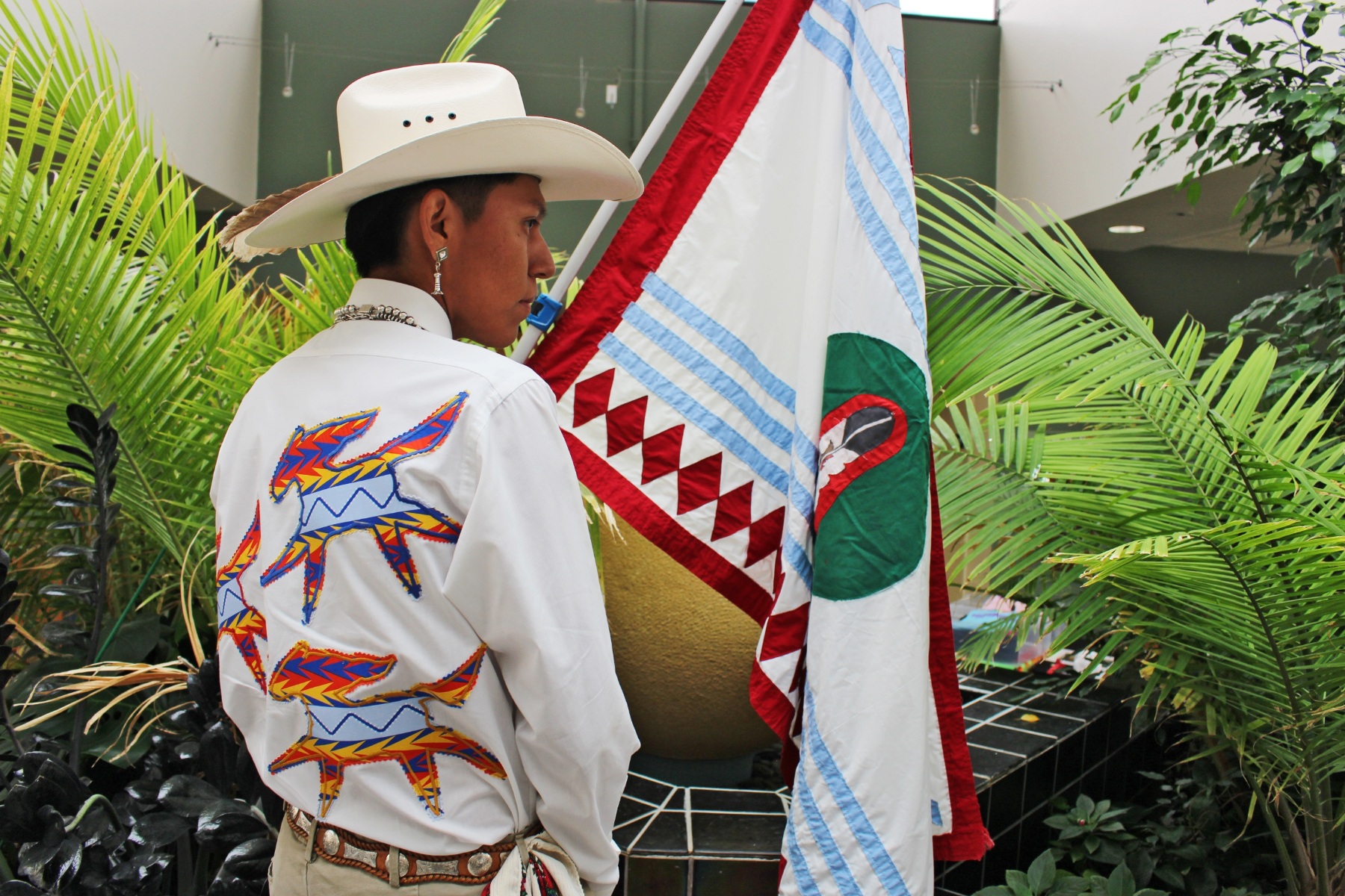 A person wears a wears a shirt he created for the Two Spirit Conference’s fashion show event.