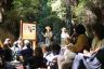 Two rangers talk to a group of park visitors.