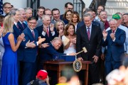 President Donald Trump, joined by Republican lawmakers, holds a gavel after signing the 