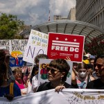 People attend a protest organized by Free DC near the Metropolitan Police Department headquarters.