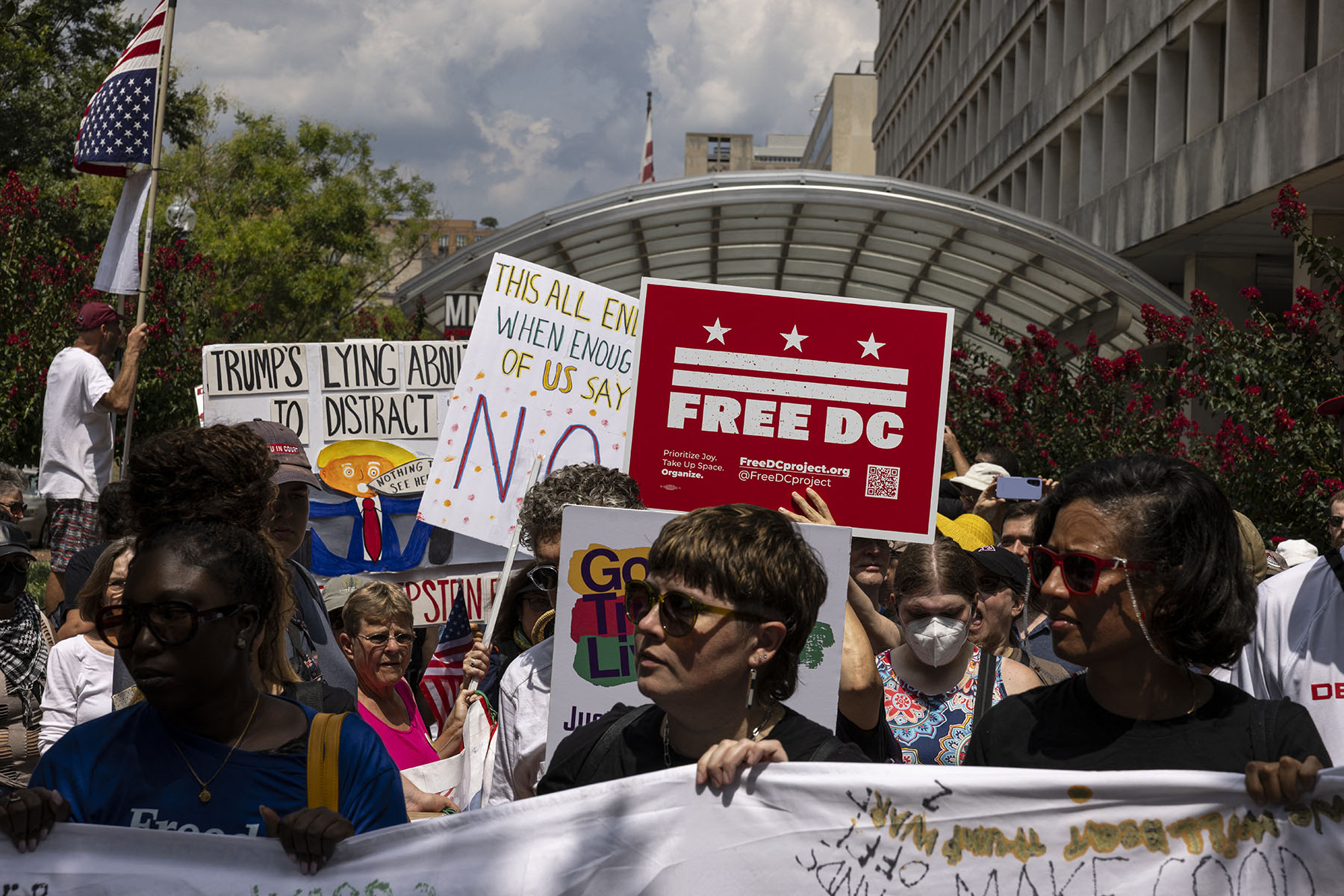 People attend a protest organized by Free DC near the Metropolitan Police Department headquarters.