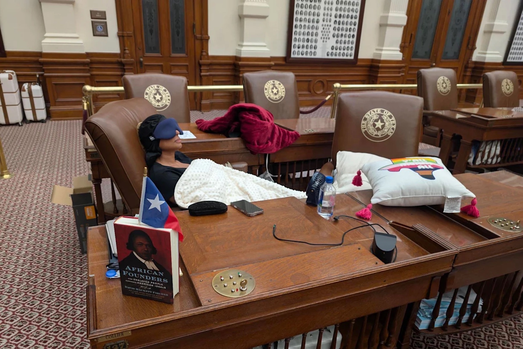 State Rep. Nicole Collier from Fort Worth sleeps at her desk on the Texas House floor.