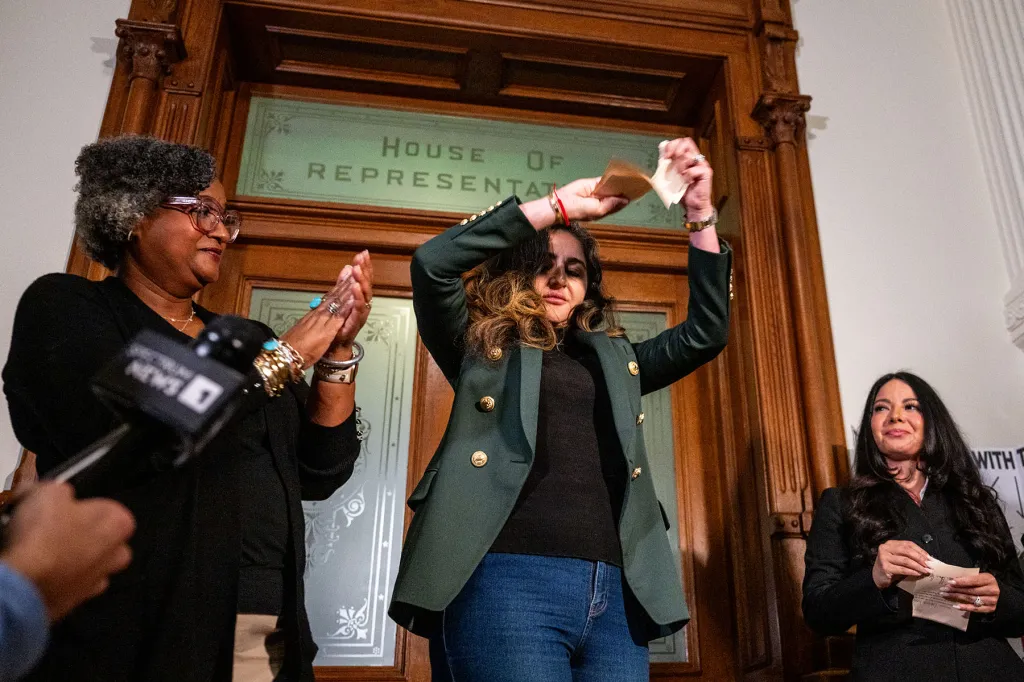 Rep. Mihaela Plesa tears her Department of Public Safety escort form during a news conference outside of the House chamber in the Texas State Capitol.