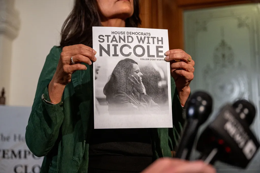 Democratic Texas Rep. Penny Morales Shaw displays a poster of Democratic Texas Rep. Nicole Collier during a news conference outside of the House chamber in the Texas State Capitol.