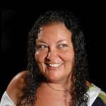 Smiling photo of Patty Berne on black background.
