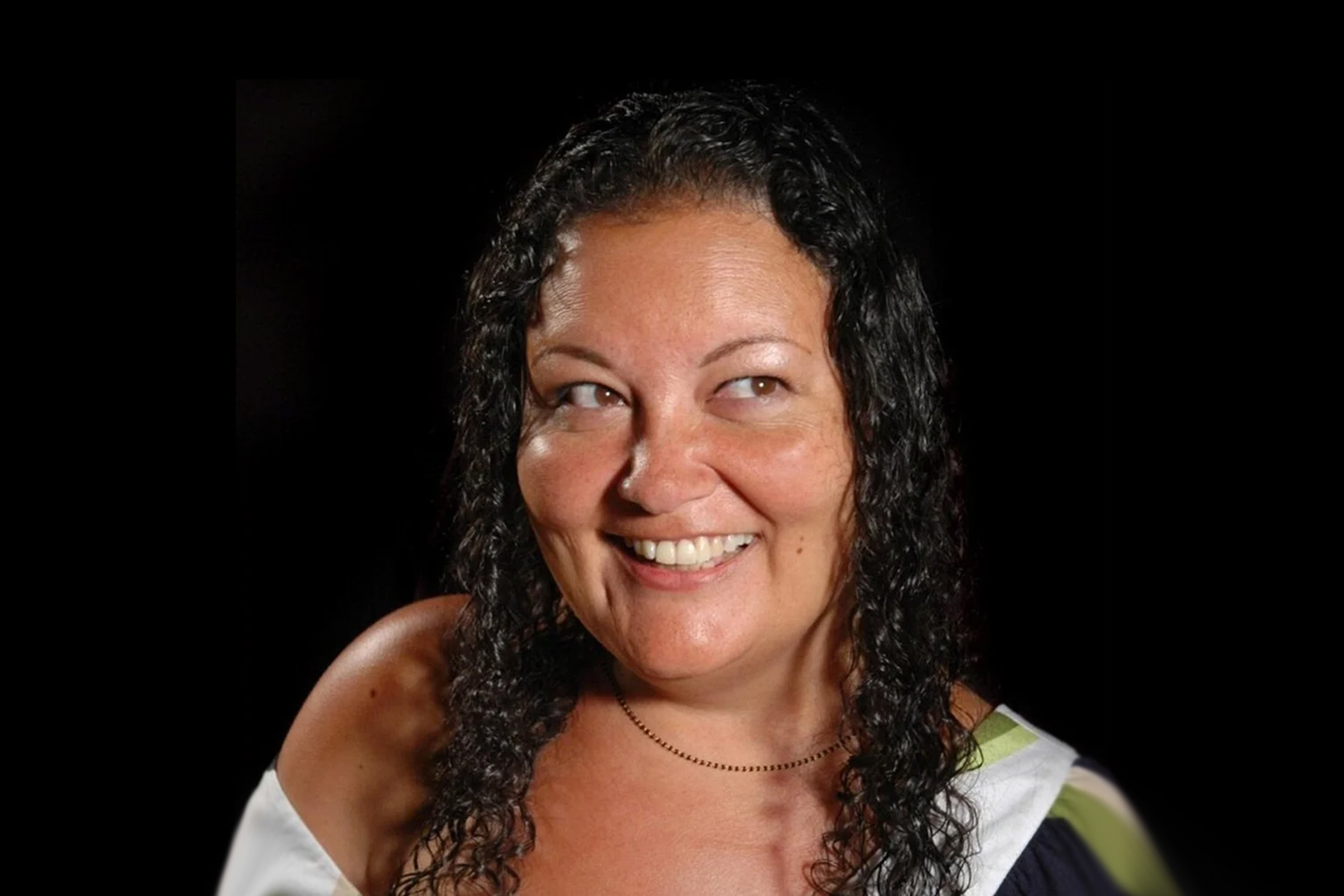 Smiling photo of Patty Berne on black background.