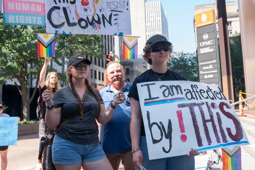 Lee and Nicole attend a protest against UPMC's cuts to gender-affirming care for patients under 19.