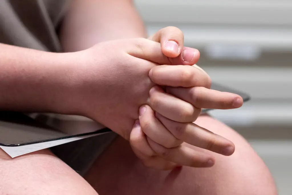 Lee squeezes his hands as he waits for his doctor at UPMC's University Center Medical Building.