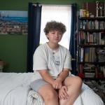 Lee poses for a portrait in his room