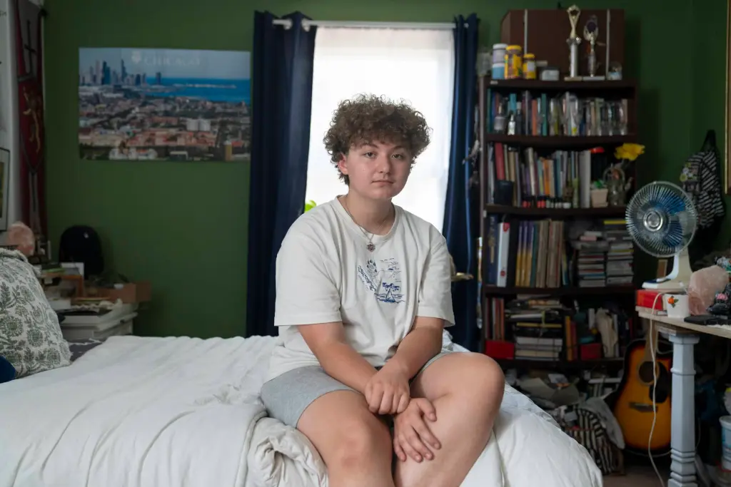 Lee poses for a portrait in his room