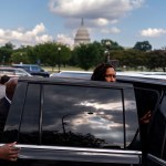 Mayor Muriel Bowser looks at the camera while stepping into a vehicle in front of the Capitol.