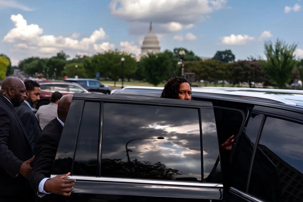 Mayor Muriel Bowser looks at the camera while stepping into a vehicle in front of the Capitol.