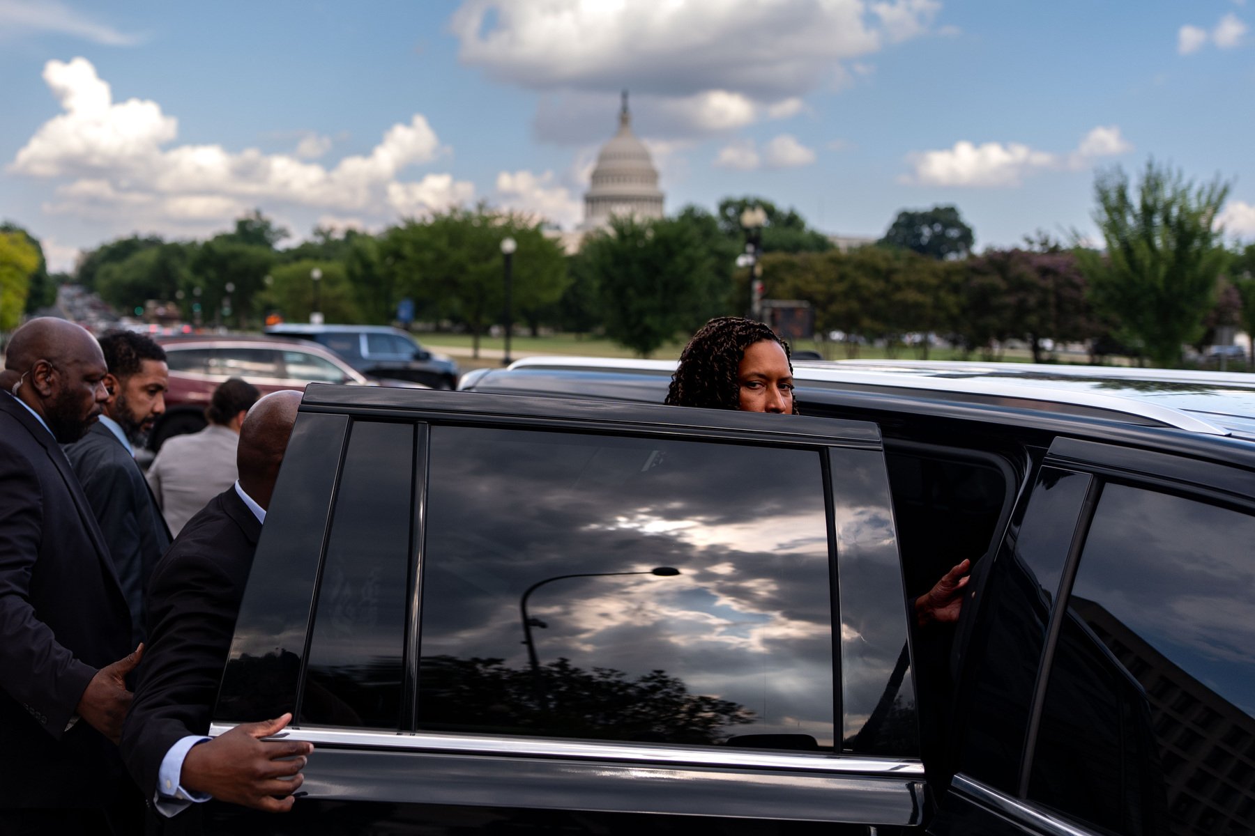 Mayor Muriel Bowser looks at the camera while stepping into a vehicle in front of the Capitol.