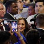 Former Vice President Kamala Harris poses for photos with supporters.
