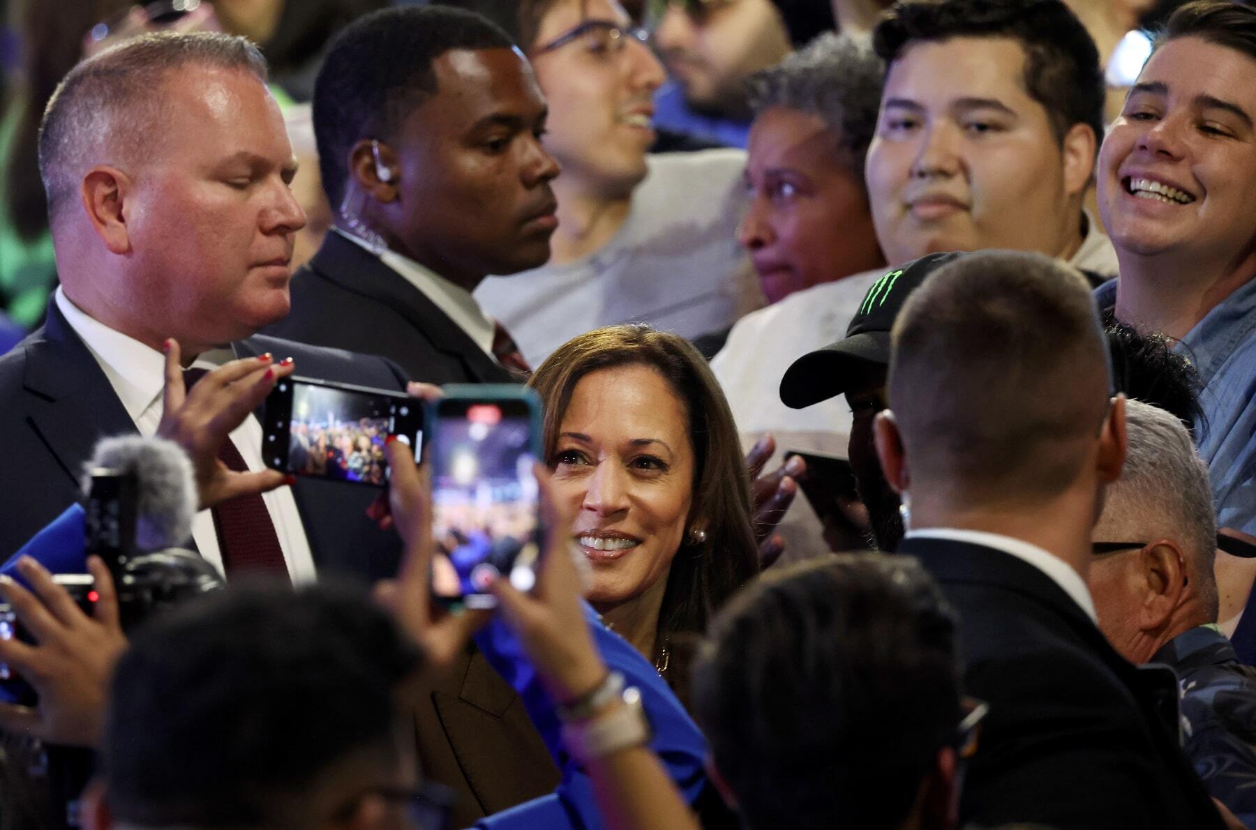 Former Vice President Kamala Harris poses for photos with supporters.