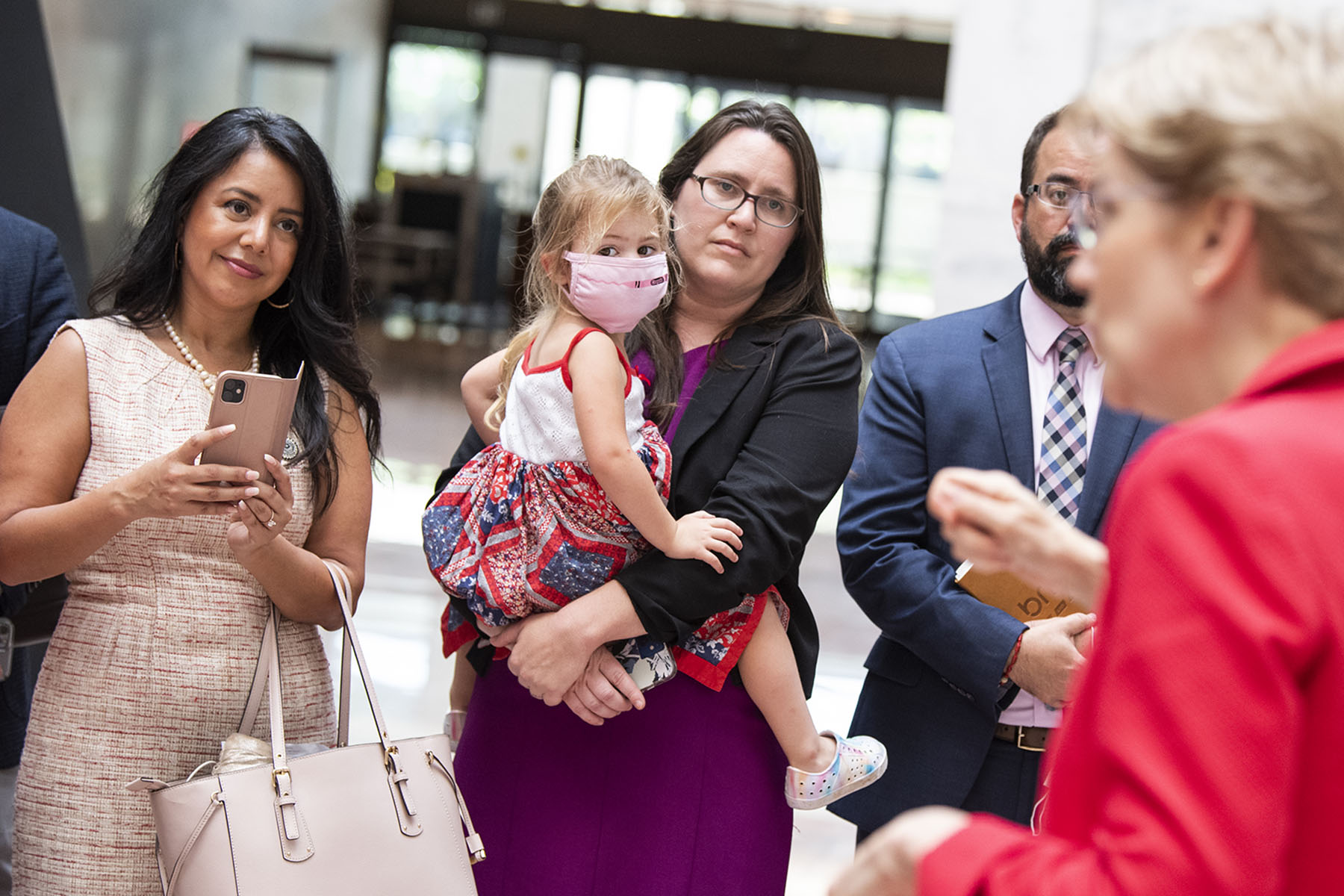 Rep. Erin Zwiener and her daughter, Lark, listen to Sen. Elizabeth Warren address Democratic members of the Texas Legislature in Washington, D.C.