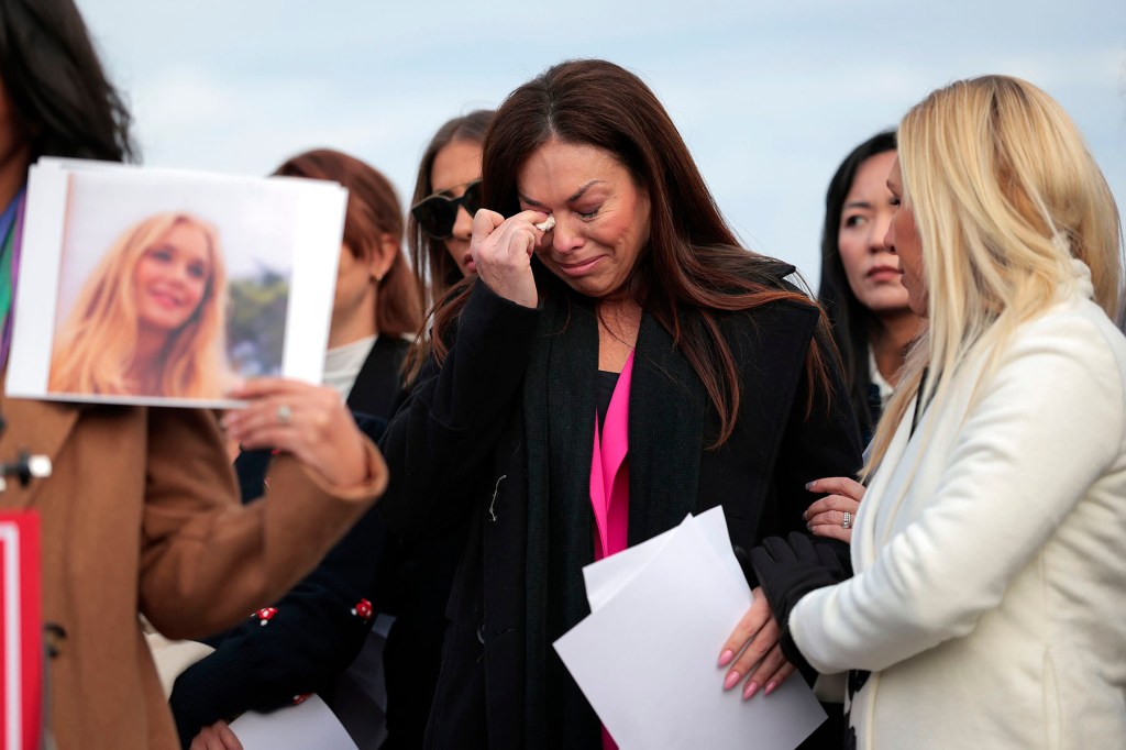 Epstein abuse survivor Haley Robson gets emotional alongside Rep. Marjorie Taylor Greene as the family of Virginia Giuffre speaks during a news conference with lawmakers outside the Capitol.
