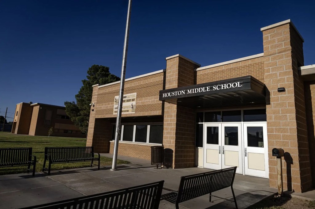 The entrance to Houston Middle School in Hobbs, New Mexico, with benches and a flagpole outside the brick building.