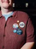 A person is shown with buttons on their shirt that say "Hong for Wisconsin" and "Make Better Possible"