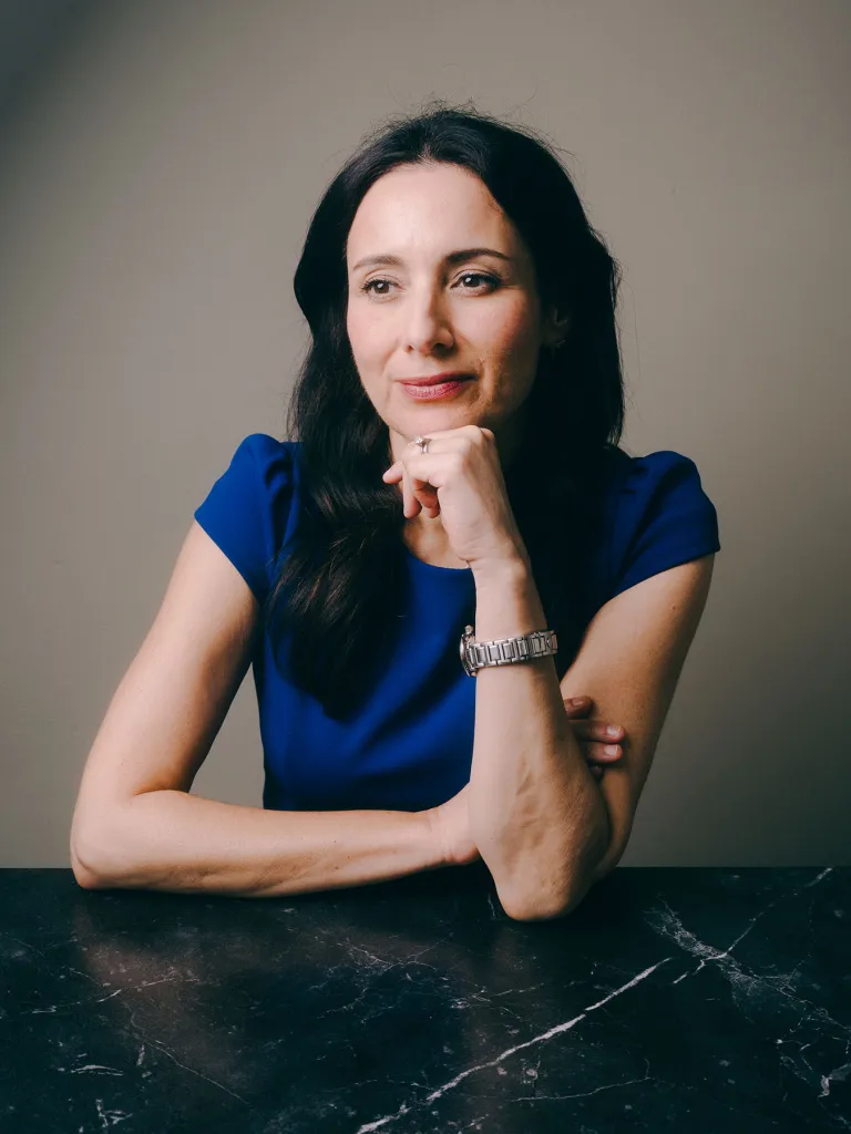 Democratic candidate for Texas Governor Gina Hinojosa poses for a portrait in a blue dress.
