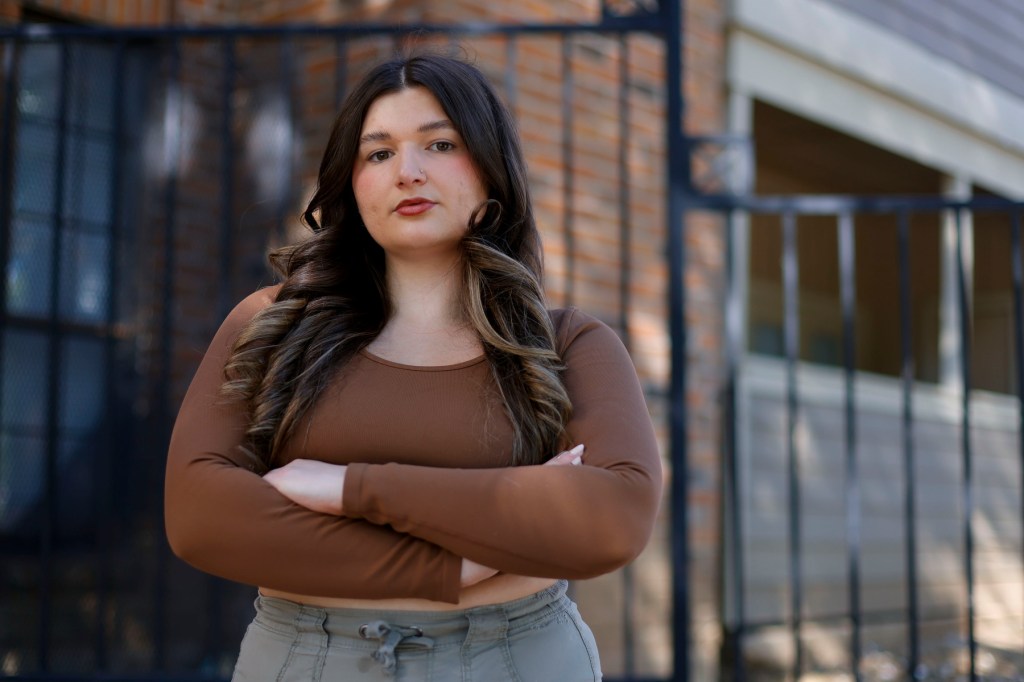 A portrait of Remick looking into the camera with arms folded.