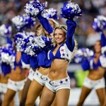 Dressed in blue and white uniforms, the Dallas Cowboys Cheerleaders perform during a game.