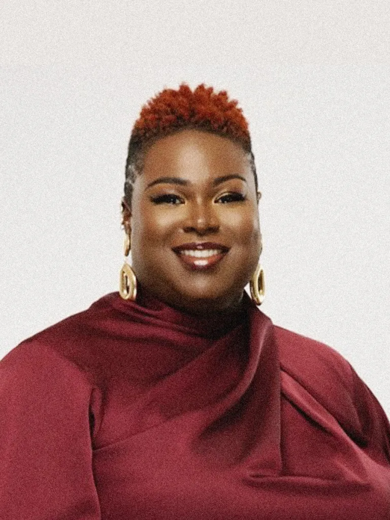 Portrait of Jenkins in a red shirt against a white backdrop